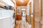Washer and dryer included in the property. This hallway is on the main level which leads to the master suite bedroom and the queen bedroom 
